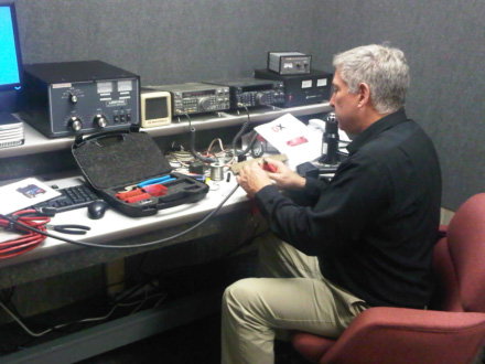 Bill Sloan, KC9ANG, TALARC Secretary and Assistant Director of the Internal Affairs Division at National Headquarters, preps antenna cables for soldering PL-259 connectors to the lines