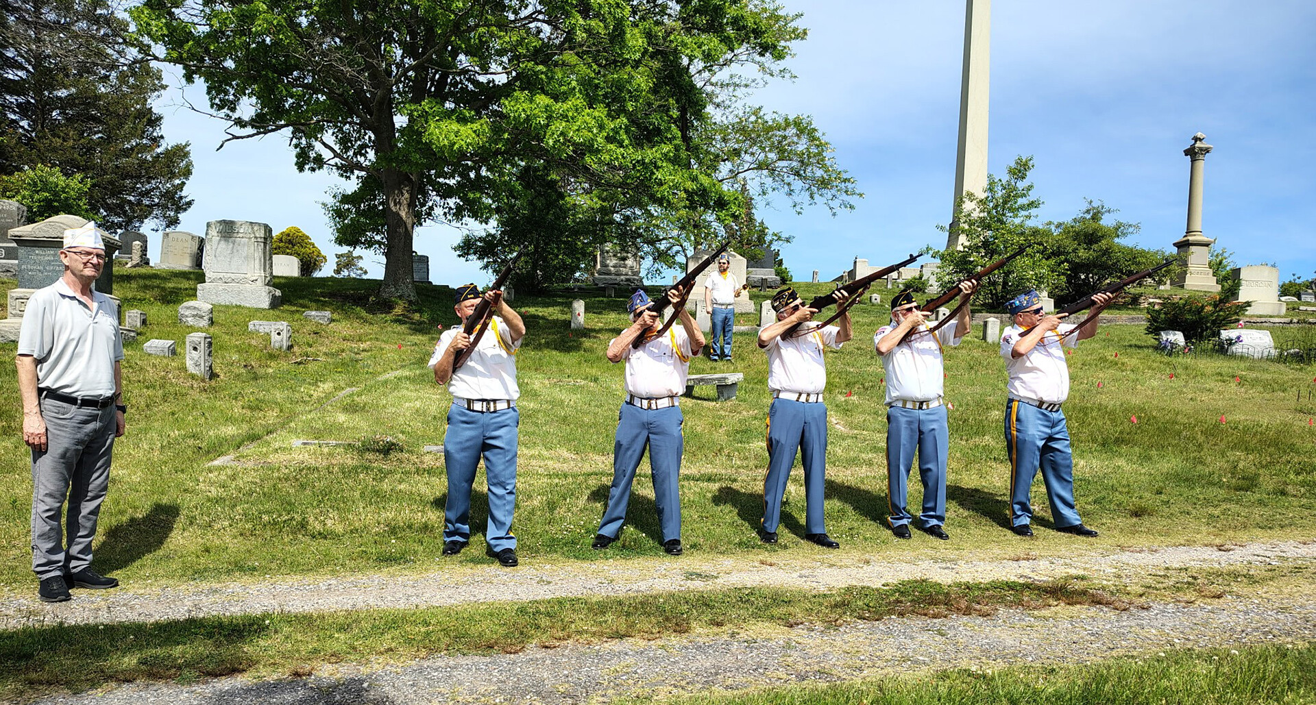 Neptune, N.J., American Legion Post 346’s color guard fires a volley over a veteran’s grave at Mount Prospect Cemetery ahead of Memorial Day. (Paul Hulse photo)