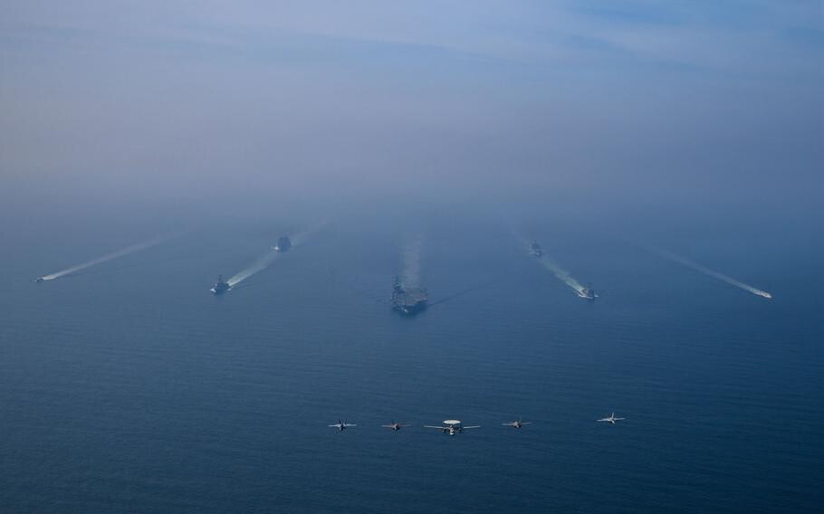 The aircraft carrier USS Abraham Lincoln leads its strike group in formation. (Jesse Monford/U.S. Navy)