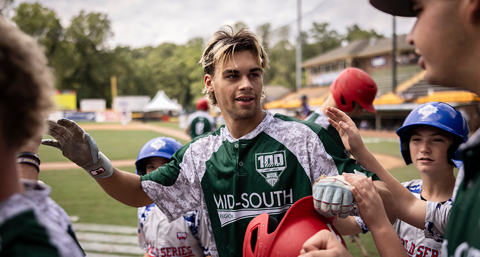 Cole Snell of Bossier City, La. Post 202 is congratulated by his teammates in the dugout after scoring a run during Game 5 of the 2025 American Legion World Series. Photo by Chet Strange