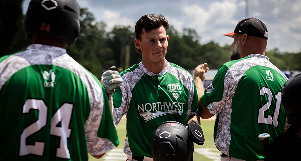 Joe Fagan of Portland, Ore. Post 158 is congratulated by his teammates after scoring a run during Game 6 of the 2025 American Legion World Series. Photo by Chet Strange