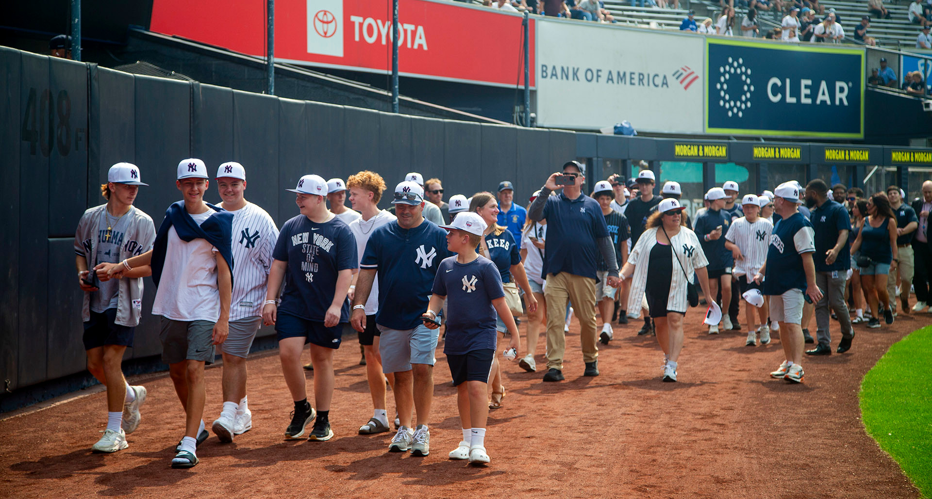 Members of the American Legion Family and Legion Baseball players walk the warning track at Yankee Stadium in honor of The American Legion Baseball Centennial. (Photo by Denise Henhoeffer)