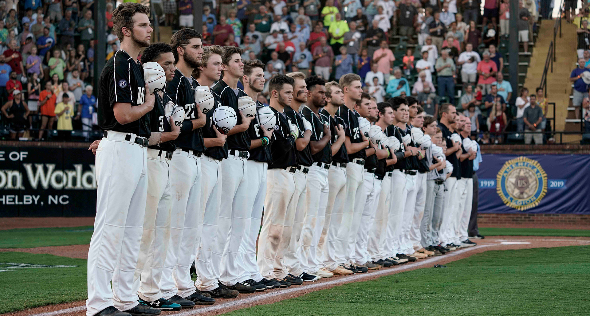 Randolph Co. (N.C.) Post 45 players stand at attention during the national anthem prior to game four of the 2019 American Legion World Series. Photo by Ryan Young/The American Legion. 
