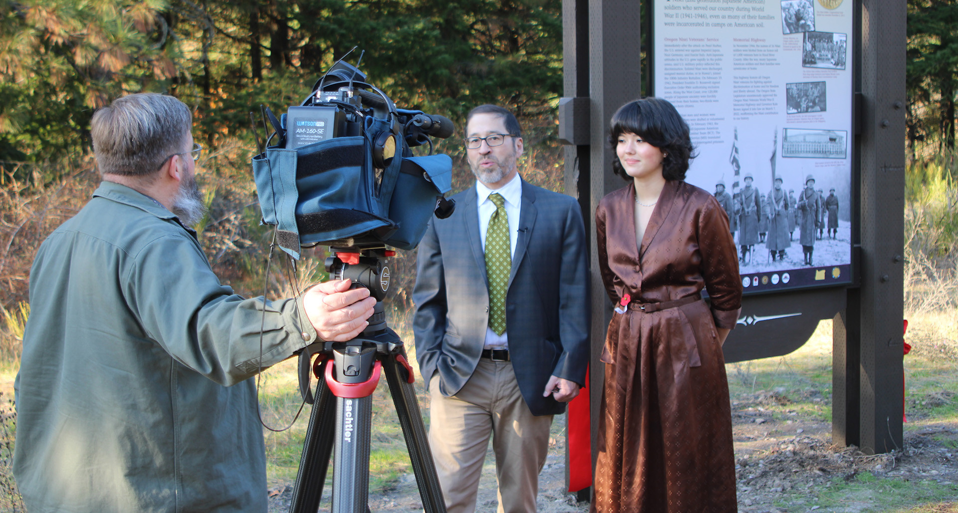 Eric Ballinger and his daughter Mia stand in front of the the Oregon Nisei Veterans Memorial Highway that honors 435 Japanese Americans from Oregon who served in World War II. Photo by John Swyers