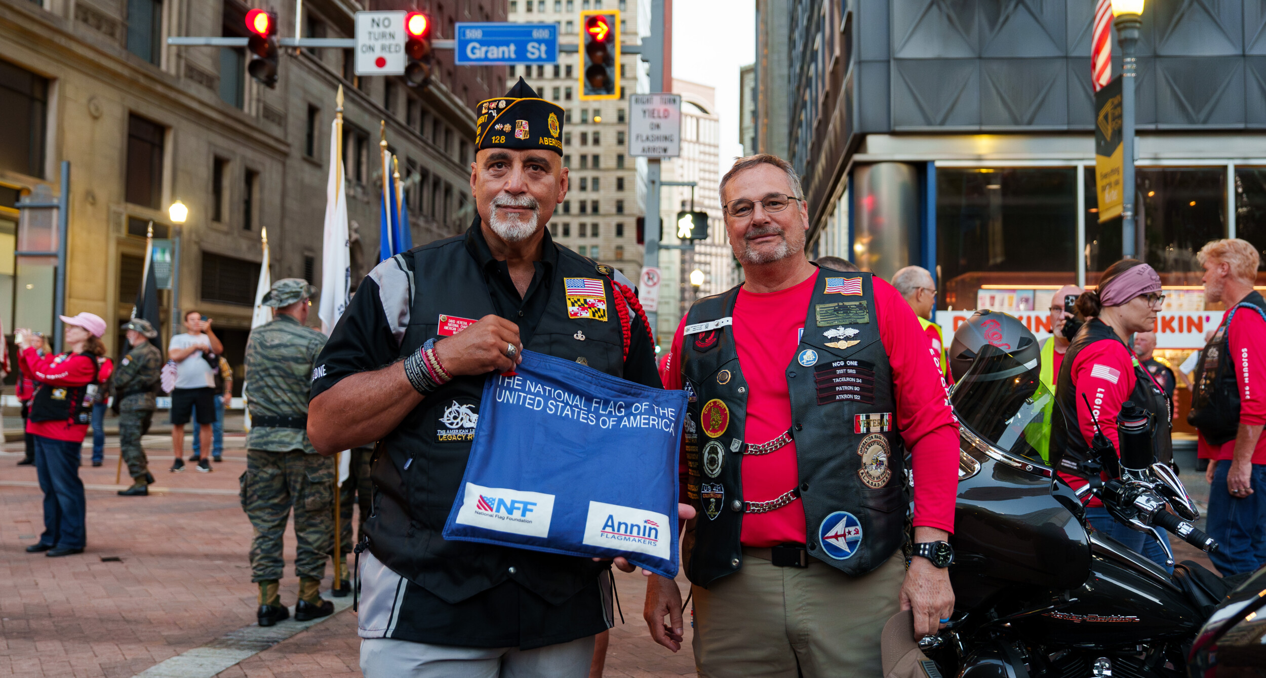 American Legion Riders National Chairman David Heredia stands with Ken George while holding the official Sojourn 250 American Flag in Pittsburgh, Pa.