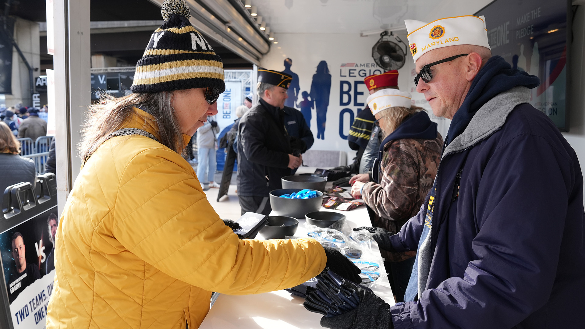 Volunteers interact with fans at The American Legion Fan Walk activation display outside of M&T Field ahead of the Army-Navy Game presented by USAA. Jennifer Blohm/The American Legion