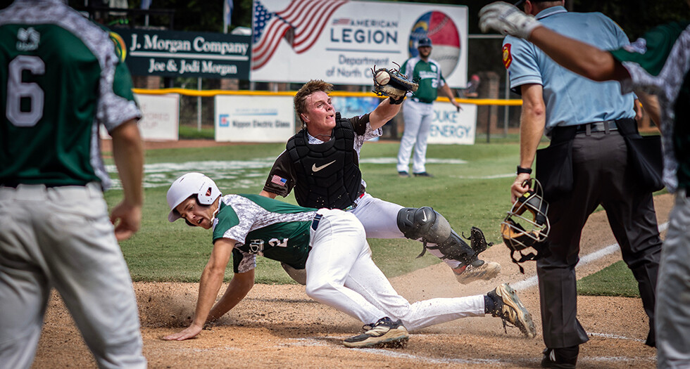 Bradyn Erickson of Lincoln, Neb. Carpet Land Post 500 tags out Brody Thompson of Tupelo, Miss. Post 49 during Game 8 of The American Legion World Series. Photo by Chet Strange