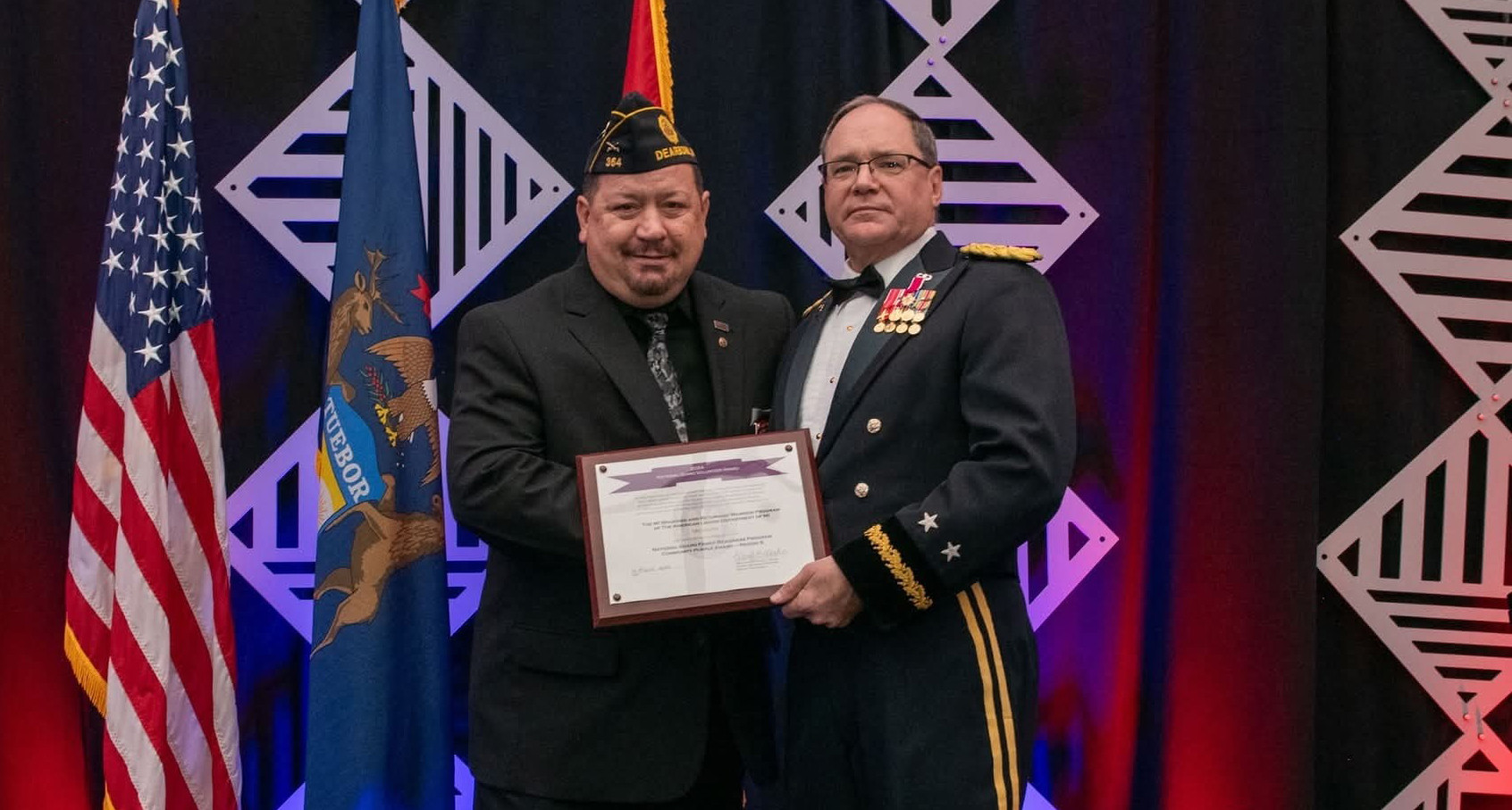 Gary Tanner, left, receives the National Guard Volunteer Award Nov. 8 for his efforts with the American Legion Department of Michigan Wounded and Returning Warrior Program.
