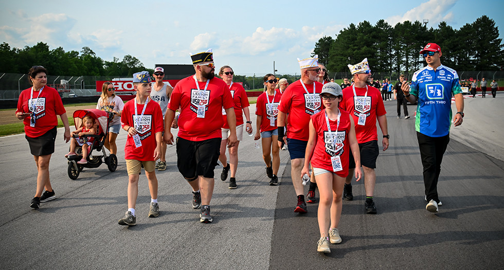 IndyCar driver Graham Rahal is joined by members of The American Legion Family to kick off their USA 250 Challenge during a track walk at the Mid-Ohio Sports Car Course. (Photo by Nickolas Wolf)