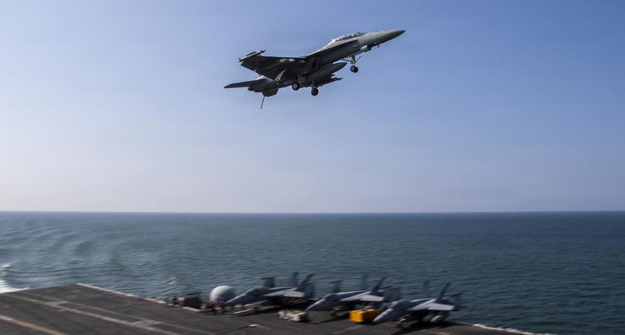 An F/A-18F Super Hornet, attached to Strike Fighter Squadron 41, flies over the flight deck of Nimitz-class aircraft carrier USS Abraham Lincoln in support of Operation Epic Fury. (U.S. Navy)