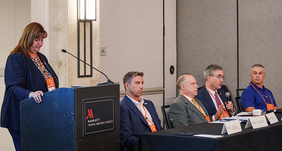 SBA District Director Jonel Hein moderating the panel of Richard Haggerty, Thomas Rossomando, Dr. Casey Mulligan and Simon Bollin. Photo by Jennifer Blohm/The American Legion