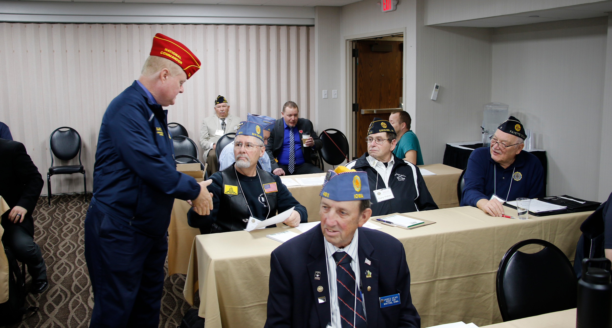 The national commander visits with members during an SAL detachment meeting.