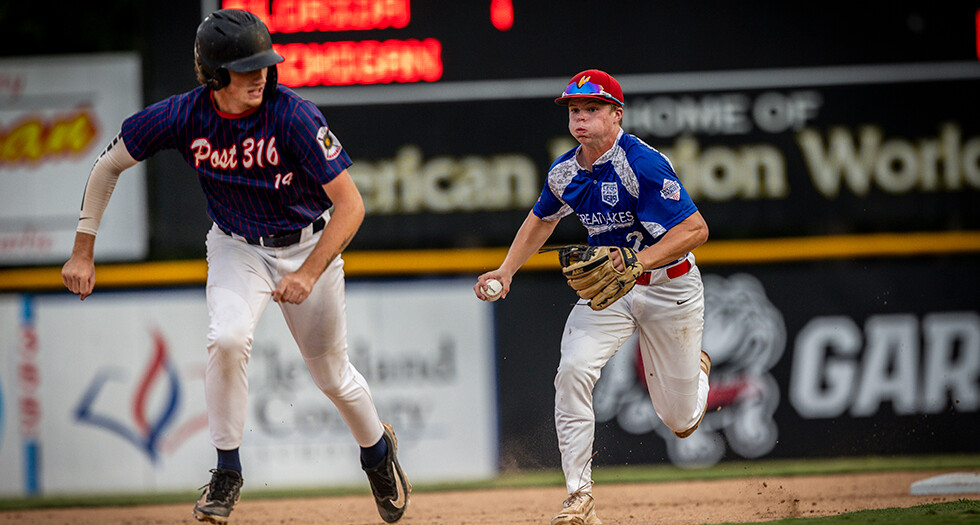 Jimmey Sequin of Midland, Mich., Berryhill Post 165 chases down Tommy Glasspoole of Jacksonville, Fla., Post 316 during Game 6 of the 2026 American Legion World Series. Photo by Chet Strange