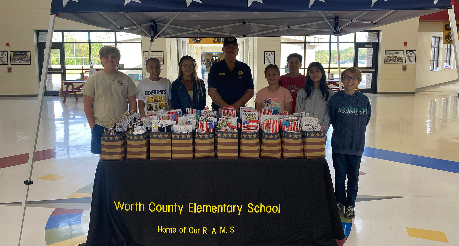 Department of Georgia Senior Vice Commander Ray Humphrey stands with students who made 250 cards for veterans.
