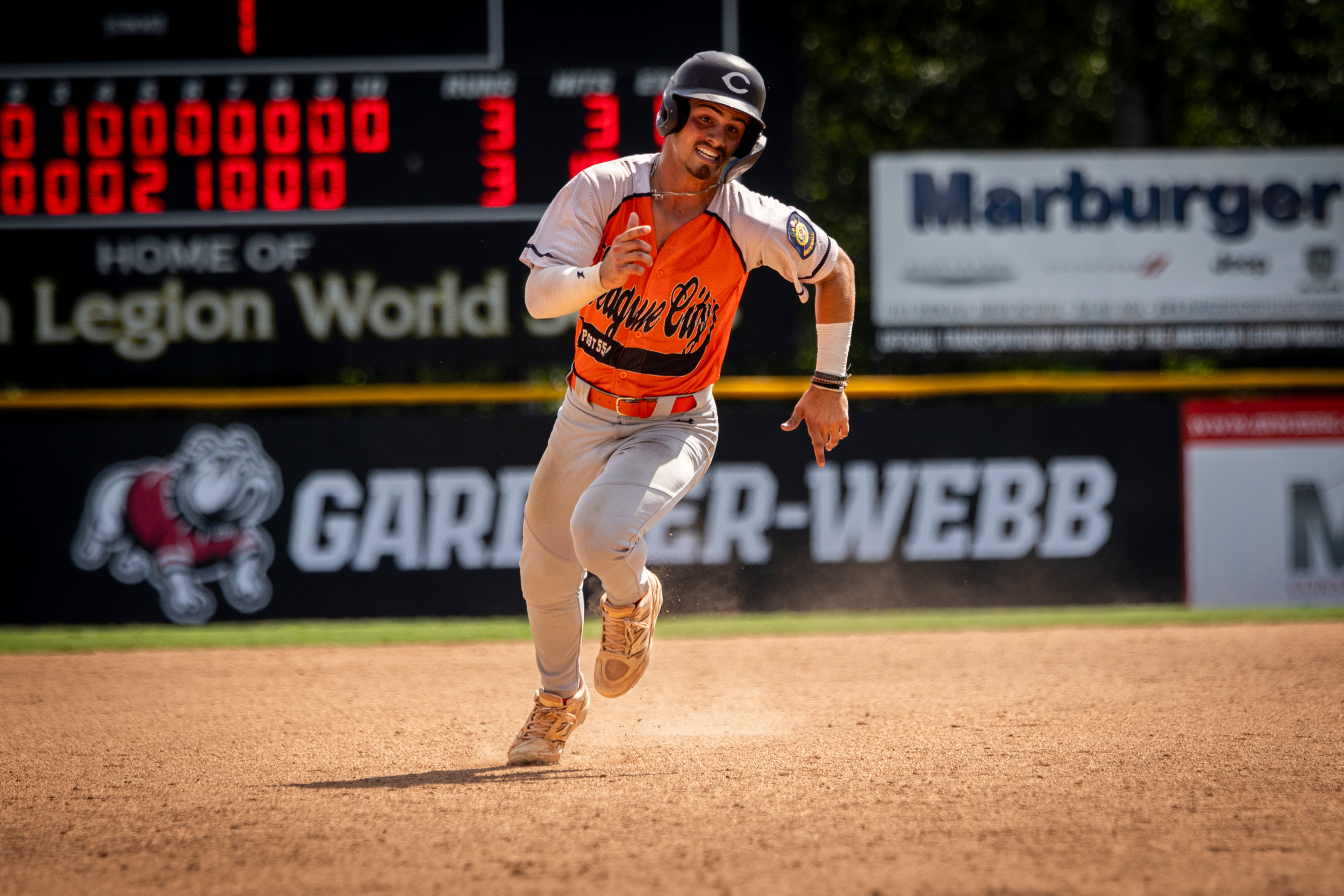 Caden Schindler of League City, Texas Post 554 scores the game winning run during Game 10 of the 2025 American Legion World Series. Photo by Chet Strange