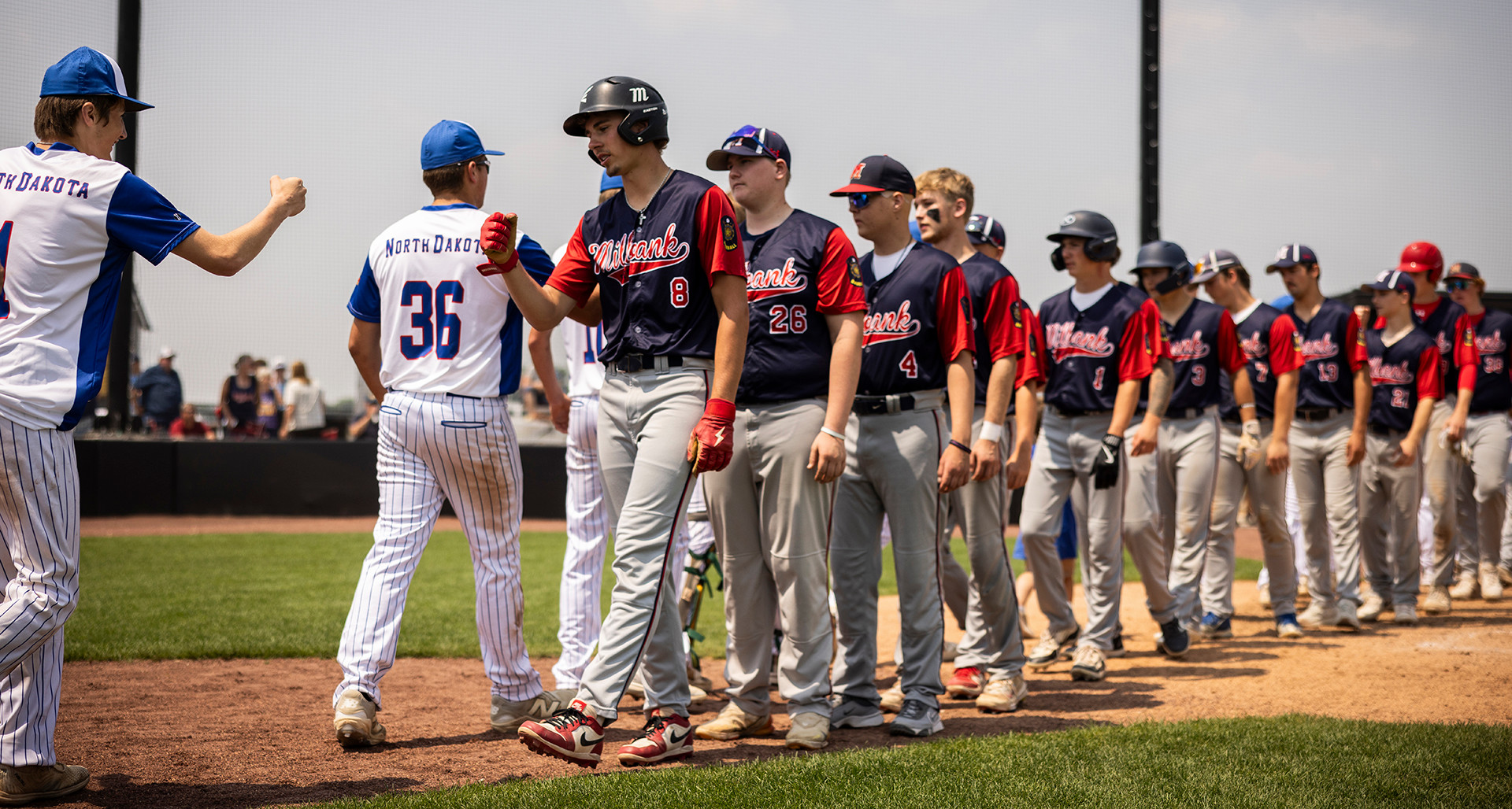 Milbank (S.D.) Post 9 and LaMoure (N.D.) Post 19 congratulate one another after game 3 of the Centennial Classic in Milbank, S.D., on Saturday, July 12. Photo by Chet Strange/The American Legion