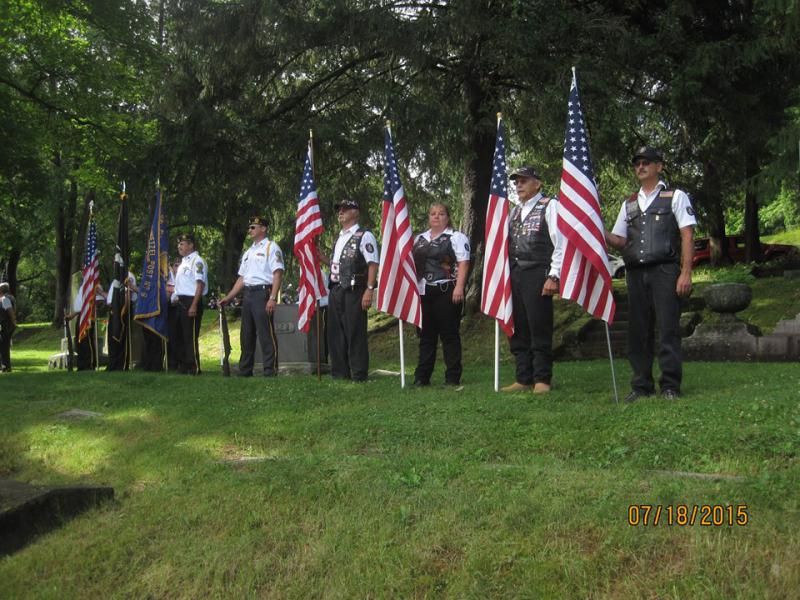 Winona Riders stand flag line for grave rededication