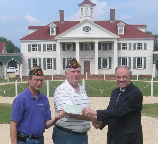 District 23 presents a check to American Village