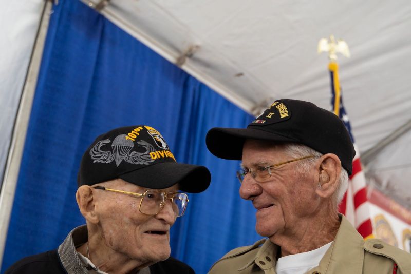 Tom Rice, right, a World War II veteran that parachuted into Normandy on June 6, 1944, as part of Operation Overlord greets fellow 101st Airborne World War II veteran George Dickson, left, on Saturday, March 2, 2019. <i>(Photo by Lucas Carter/The American Legion)</i>