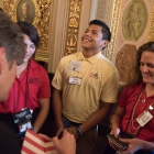 Keven Hernandez Nuno, center reacts with excitement after Joni Ernst (R-IA) in the Senate Reception Room in the US Capitol Building signed a book for him. American Legion Boys Nation and American Legion Auxiliary Girls Nation take to Capitol Hill to meet with their senators and legislative staff on Thursday, July 27, 2017. Photo by Lucas Carter / The American Legion.