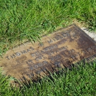 Before the cleanup - the grass around the grave marker was overgrown, and the marker itself was tarnished and weathered. Photo by Holly K. Soria/The American Legion