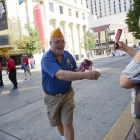William Williams from squad 29 in Oregon hands out American flags to people watching the parade through downtown Reno, Nev. on Sunday, August 20, 2017. Photo by Clay Lomneth / The American Legion. 