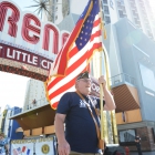 Past National Vice Commander Doug Haggan carries an American flag in the American Legion parade through downtown Reno, Nev. on Sunday, August 20, 2017. Photo by Clay Lomneth / The American Legion. 
